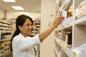 Photo by National Cancer Institute on Unsplash Pharmacist stocking shelf
